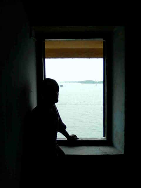 Man looking outside window