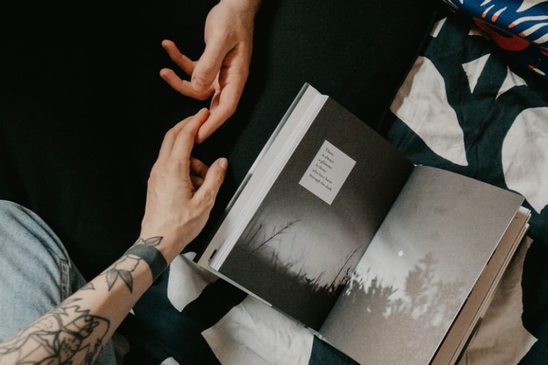 person holding black and white book