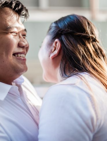 man in white polo shirt kissing woman in white shirt